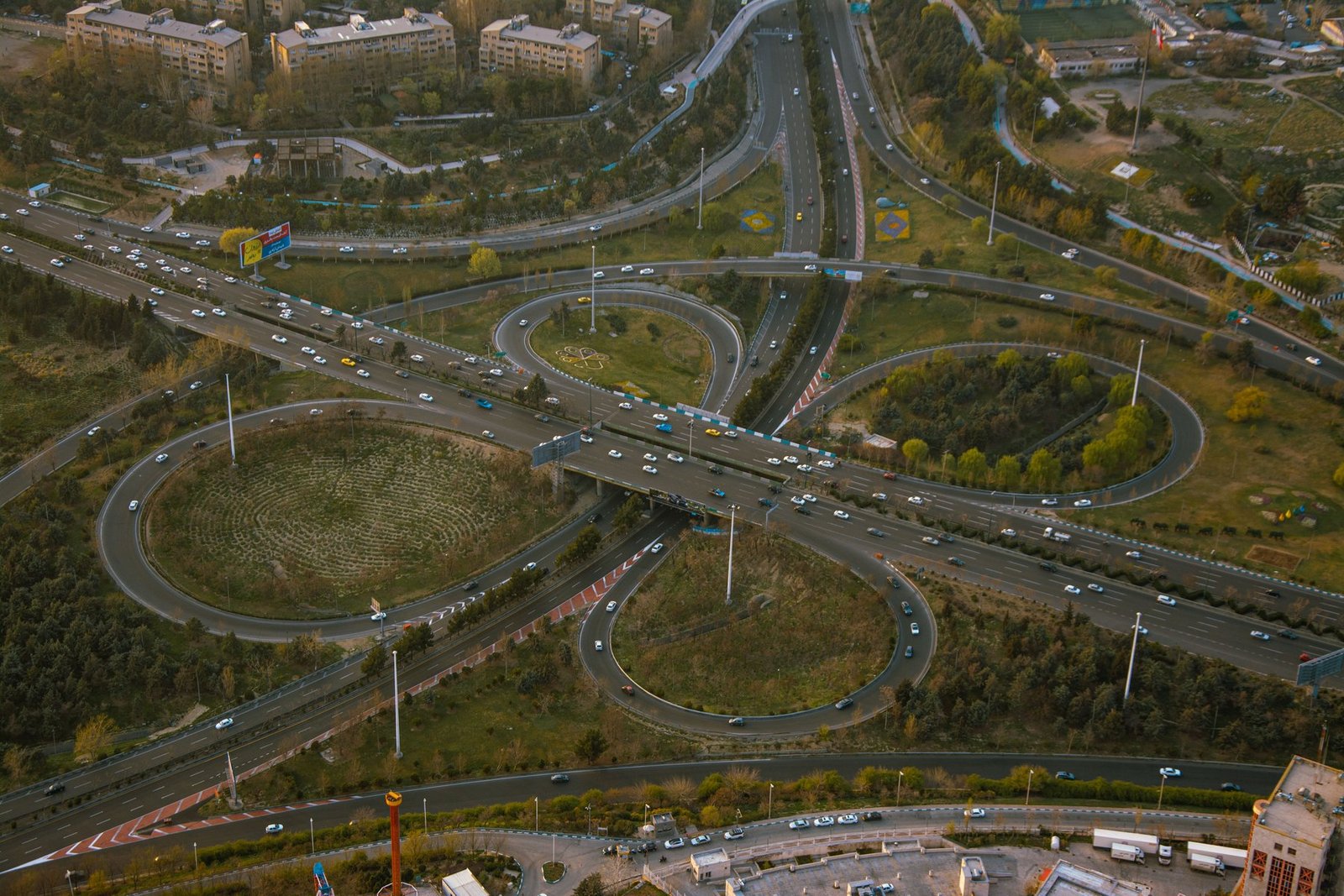 A highway interchange curving through suburban development
