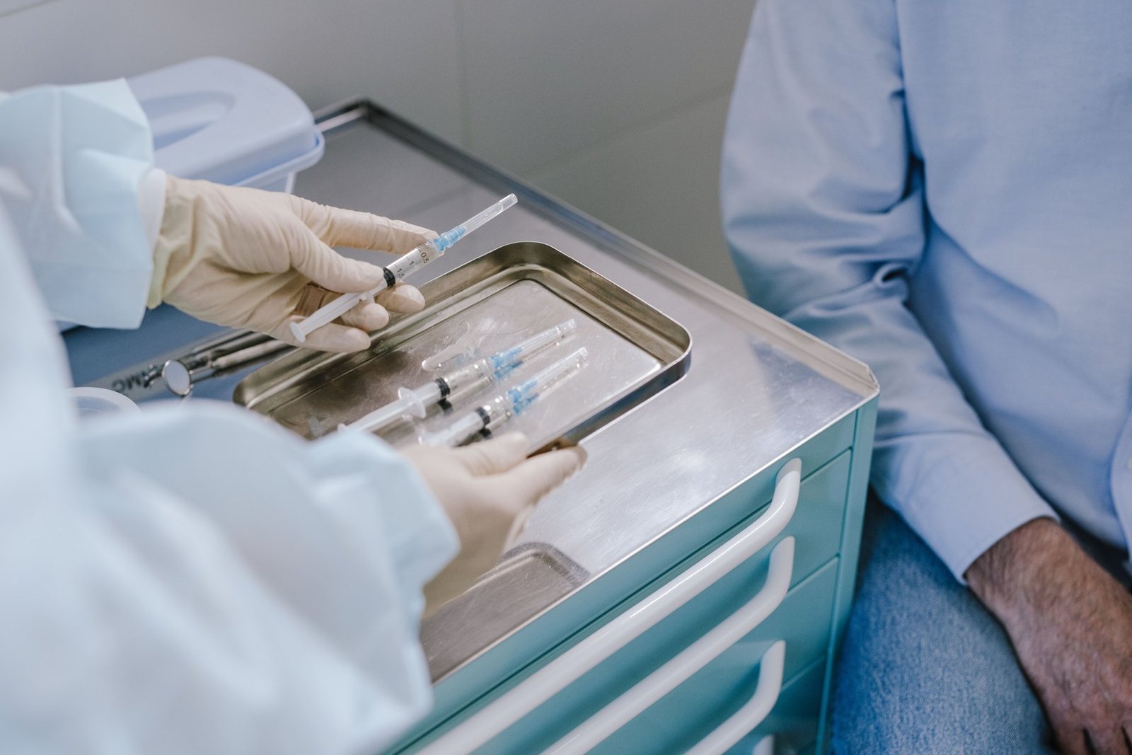 A clinician preparing an injection into the knee joint