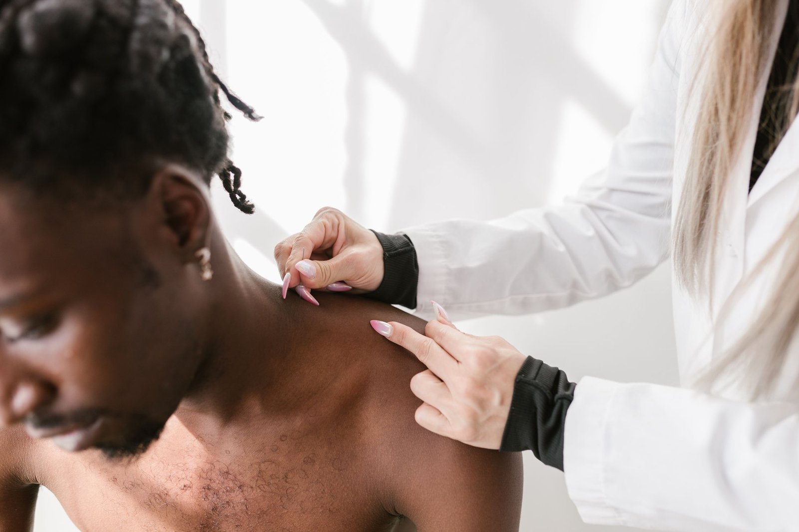 A clinician testing the range of motion in a patient’s shoulder